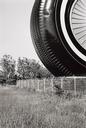 Untitled  [Large Tire By Fence]